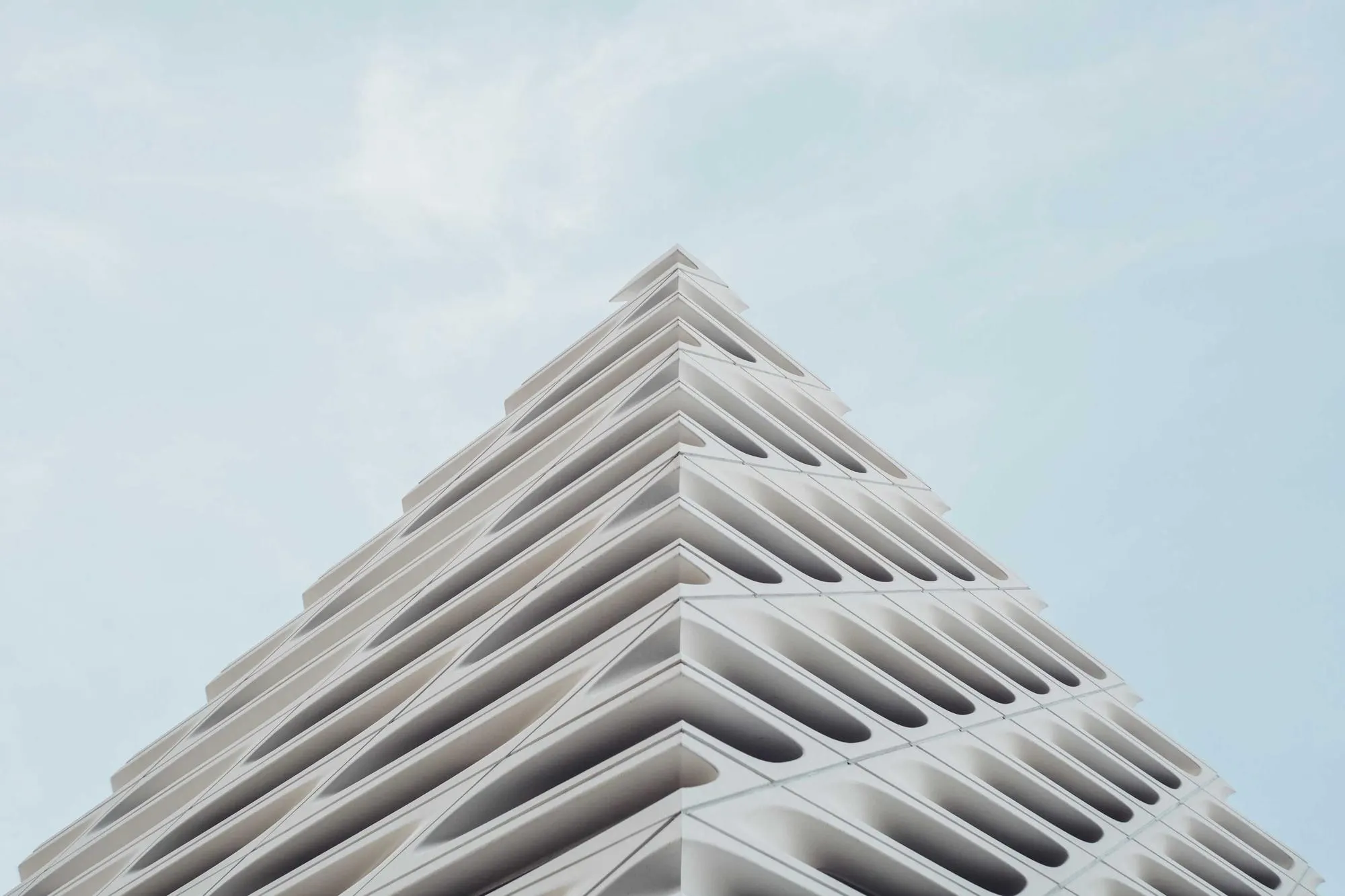 White stepped concrete facade against a pale sky