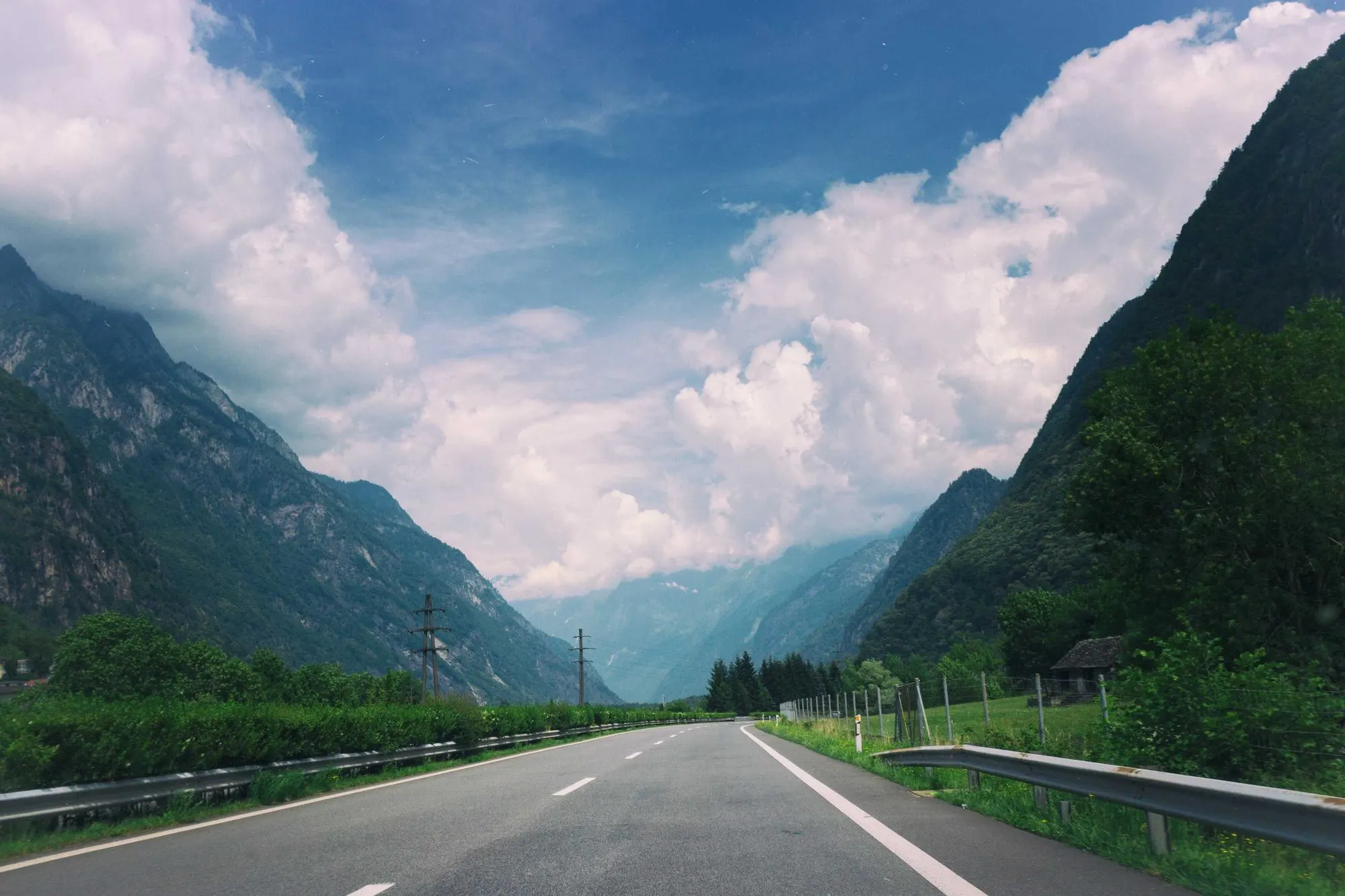 Empty road running through a deep mountain valley